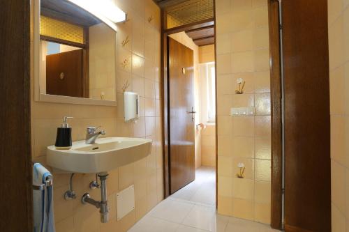 a bathroom with a sink and a mirror at Apartments and rooms by the sea Nemira, Omis - 2781 in Omiš