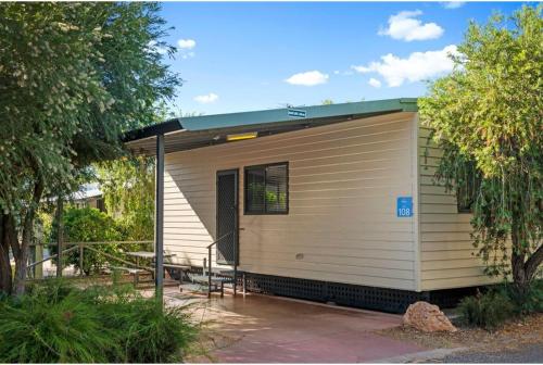 a tiny house with a porch and a patio at Discovery Parks - Alice Springs in Alice Springs