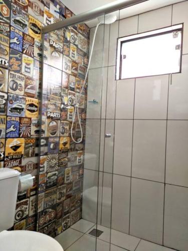a bathroom with a shower with a glass door at Tiny House Paraiso Minicasas Com Hidromassagem in Pouso Alegre