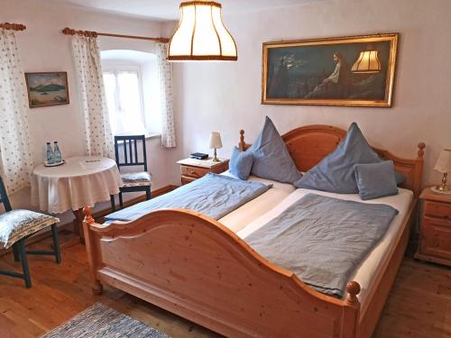 a bedroom with a large bed and a table at Pension Brucker in Aschau im Chiemgau