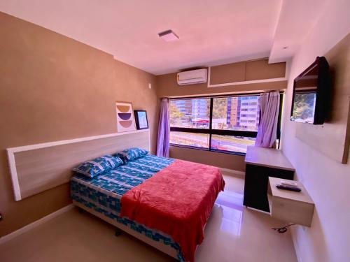 a small bedroom with a bed and a window at Ondina Apart Hotel Residences in Salvador
