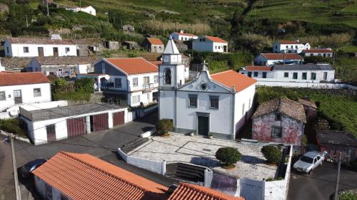 an aerial view of a small town with a church at Alojamento Local M&I in Lajes das Flores