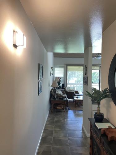 a hallway of a living room with a couch and a table at Turtle Bay Hale Lani Condo in Kahuku