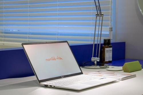 a laptop computer sitting on top of a desk at Nomad Aank Hotel Gumi in Gumi