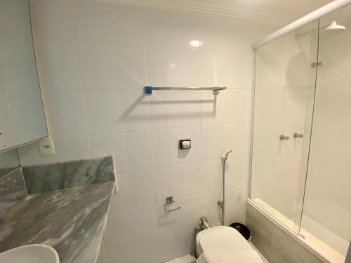 a bathroom with a toilet and a shower at Ondina Apart Hotel Residences in Salvador