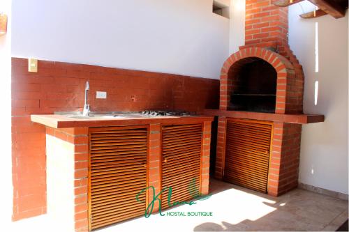 a brick kitchen with a sink and an oven at K Luna Hostal Boutique in Ríohacha