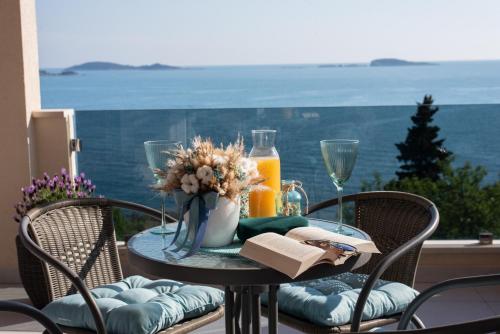 a table with a plate of food and a glass of orange juice at Blue Ivy in Mlini