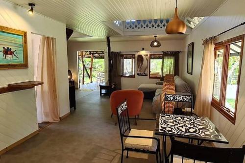 a living room with a couch and a table and chairs at Green Villa Moorea in Temae