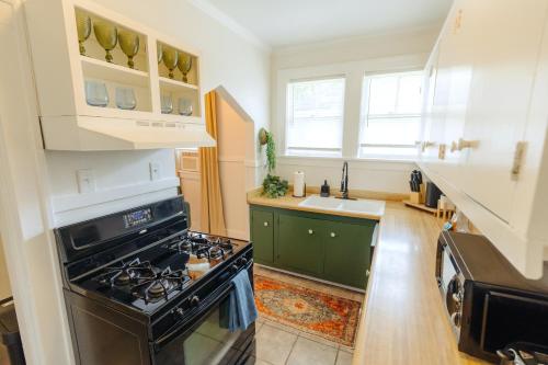 a kitchen with a stove and a sink at Historic Revival King Bed Midtown Memphis 66 Fast WiFi Free Parking Yes Pets in Memphis