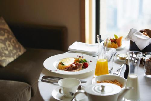 a table with a plate of food on a table at InterContinental Hotel Osaka by IHG in Osaka