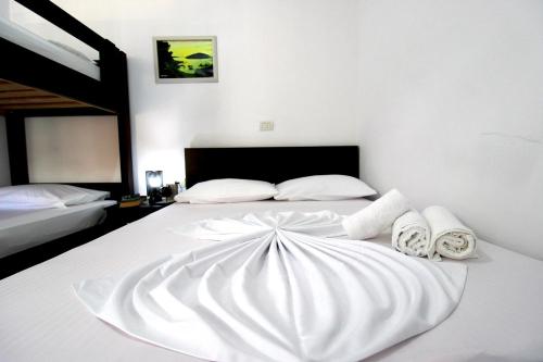 a large white bed with towels on it at Vila Reni Risi in Ksamil