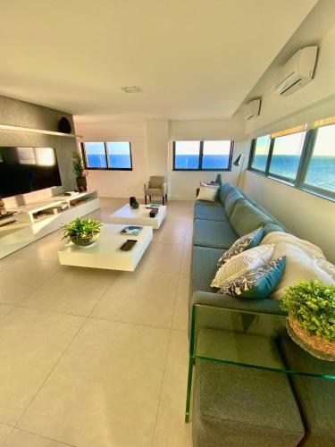 a large living room with a couch and a table at Ondina Apart Hotel Residences in Salvador