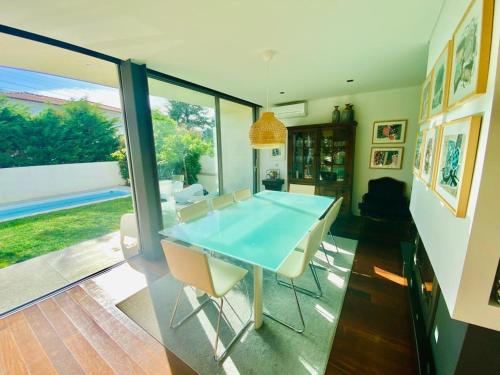a dining room with a blue table and chairs at Portugal Holidays Villa in Barcelos