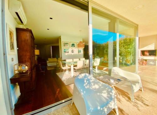 a living room with glass doors and a living room with a couch at Portugal Holidays Villa in Barcelos