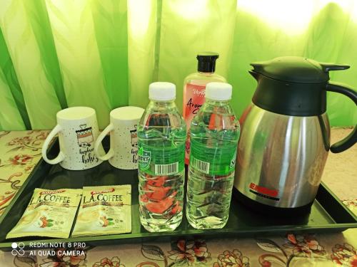 a tray with bottles of water and a coffee maker at New Garden View GF Double Room FREE parking in Batu Unjor