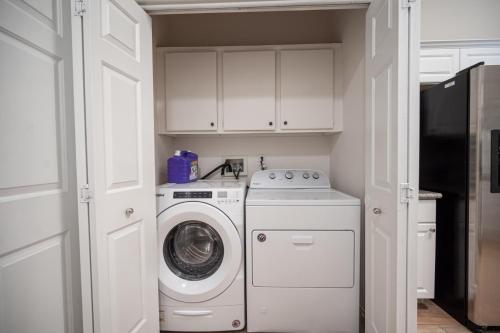 a washer and dryer in a kitchen with white cabinets at Beautiful Las Vegas Home in Las Vegas