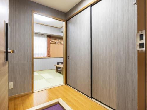 a room with sliding doors and a hallway at Hotel Wing International Nagoya in Nagoya
