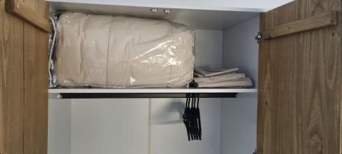 a closet with a plastic bag on a shelf at Nicaragua 2100 in Montevideo