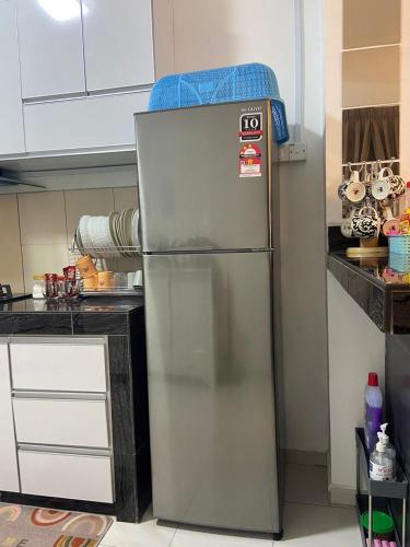 a stainless steel refrigerator in a kitchen at Rosnah Homestay in Kampong Ayer Resam