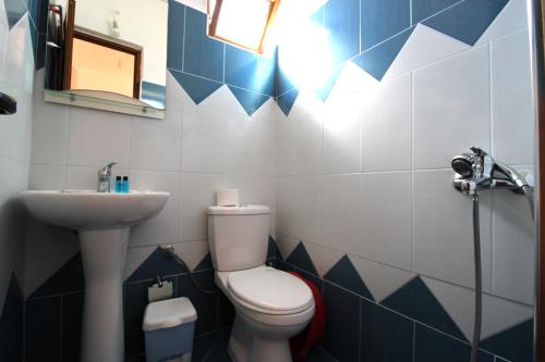 a bathroom with a toilet and a sink at Vila Reni Risi in Ksamil