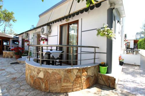 a building with a round patio in front of it at Vila Reni Risi in Ksamil
