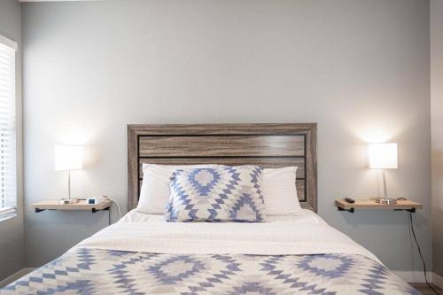 a bedroom with a bed with two lamps on both sides at Gorgeous Las Vegas home with RV parking in Las Vegas