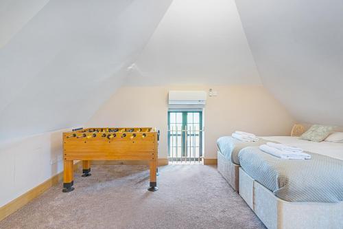 a room with a table in the middle of a bedroom at The Roost Group - Meadow Lodge - Hot Tub in Kent