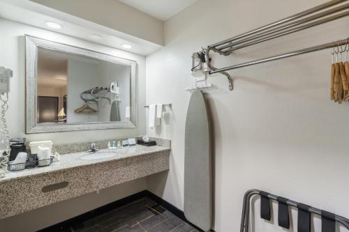 a bathroom with a sink and a mirror at Quality Inn Cleveland in Cleveland