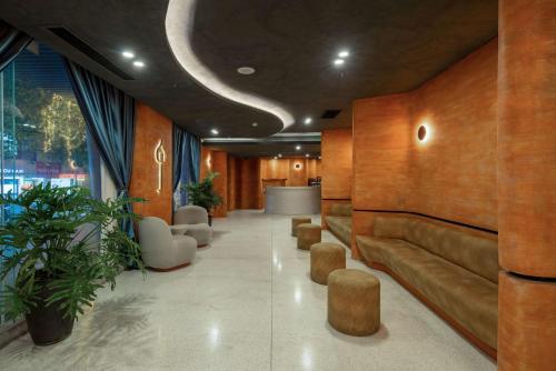 a lobby with a couch and chairs and a table at Jacayl Hotel - Cầu Giấy in Hanoi