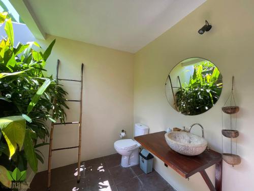 a bathroom with a sink and a mirror at The Jungle House in Canggu