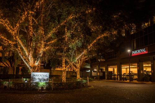 a group of trees with christmas lights in front of a building at PARKROYAL Darling Harbour, Sydney in Sydney