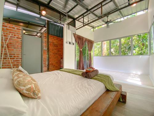 a large bed in a room with a large window at Tingkat Valley in Ipoh