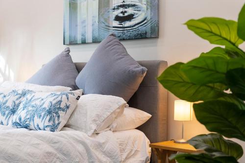 a pile of pillows on a couch next to a lamp at Gunsynd Studio Apartment in Scone
