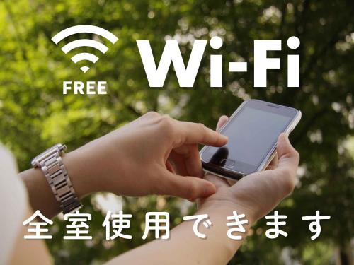 a person holding a cell phone in their hands at Hotel Route-Inn Mojiko in Kitakyushu
