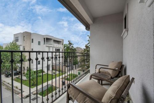 a balcony with chairs and a view of a building at 3BR 3Ba Upscale Luxury Home in The Heights in Houston