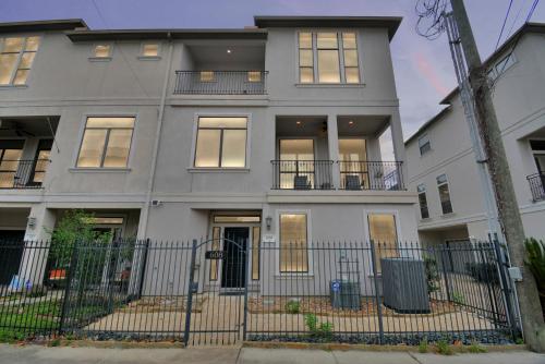 a white house with a fence in front of it at 3BR 3Ba Upscale Luxury Home in The Heights in Houston