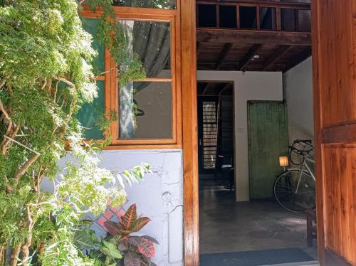 an open door of a house with a window at Historical townhouse in city center in Tainan