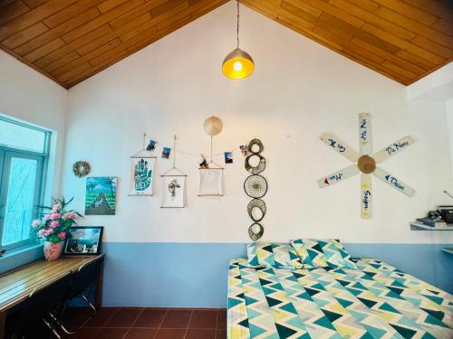 a room with a bed and a cross on the wall at Vietnam Phuot Real Home in Kon Tum