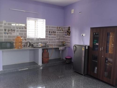 a kitchen with a sink and a refrigerator at Two Bedroom Flat Non AC Varun Vihar Near Horsley Hills in Kurabalakota