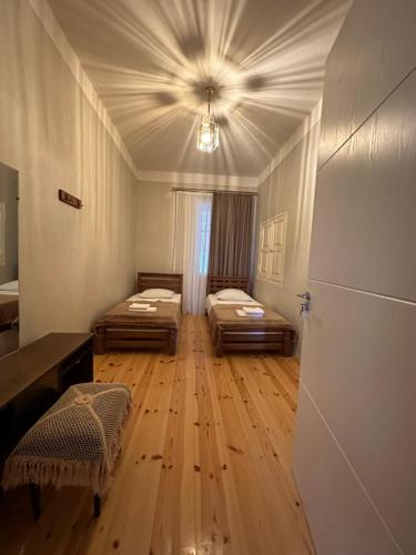 a large room with two beds and a ceiling at ,,Anna's" Guesthouse in K'vemo Alvani