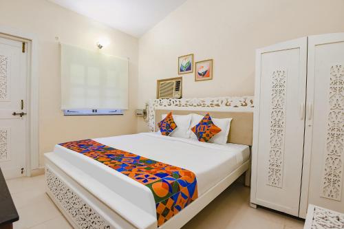 a bedroom with a large white bed in a room at FabHotel Prime Pool Point Highland, Candolim Beach in Candolim