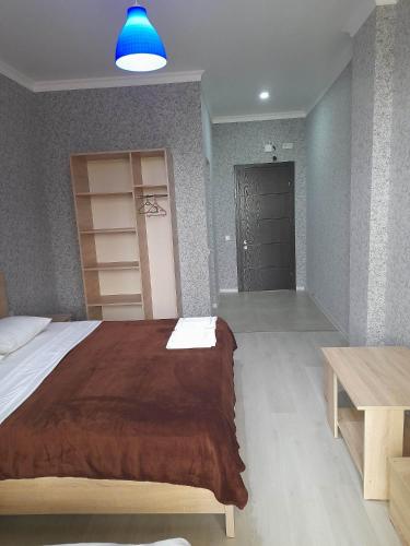 a bedroom with a large bed and a blue light at Golden House in Anaklia