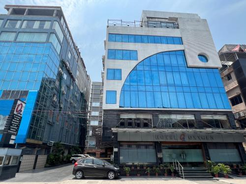 a car parked in front of a tall building at Hotel O2 Oxygen in Kolkata