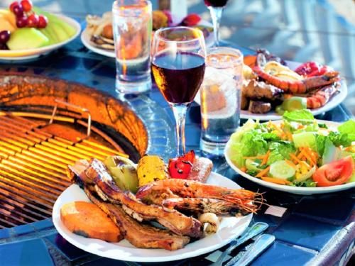 a table topped with plates of food and a grill at LiVEMAX RESORT Izu Shimoda in Shimoda