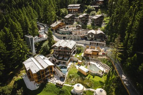 an aerial view of a large house in the forest at Nomad by CERVO Mountain Resort in Zermatt