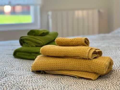 una pila de toallas sentadas encima de una cama en Apartamento Aguanaz 1, en Entrambasaguas