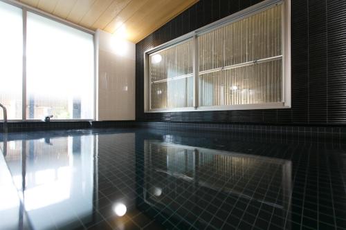 a swimming pool with a window in a building at Osaka Corona Hotel in Osaka