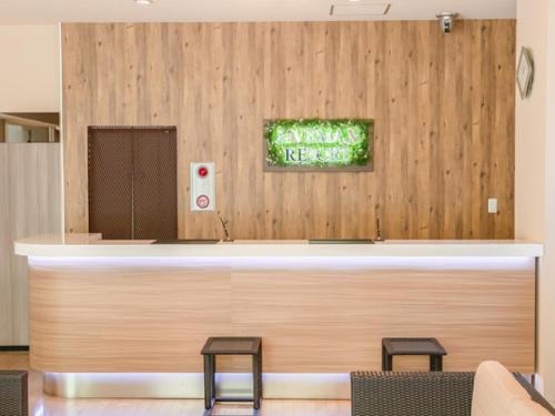 a lobby with a counter with two stools at LiVEMAX RESORT Kusatsu Onsen in Kusatsu