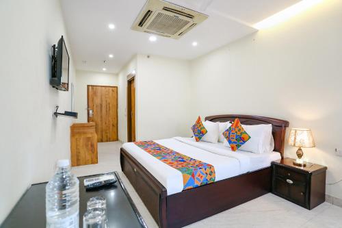 a bedroom with a bed and a desk in a room at FabHotel F9 NSP in New Delhi