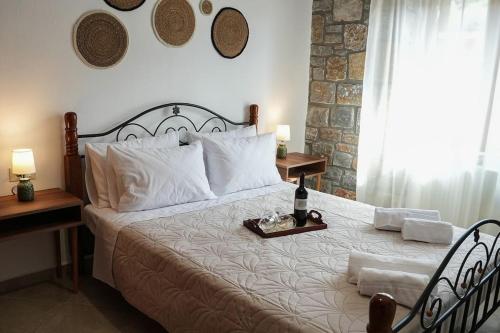 a bedroom with a large bed with a tray on it at Mountain House Perampela in Nofaliás